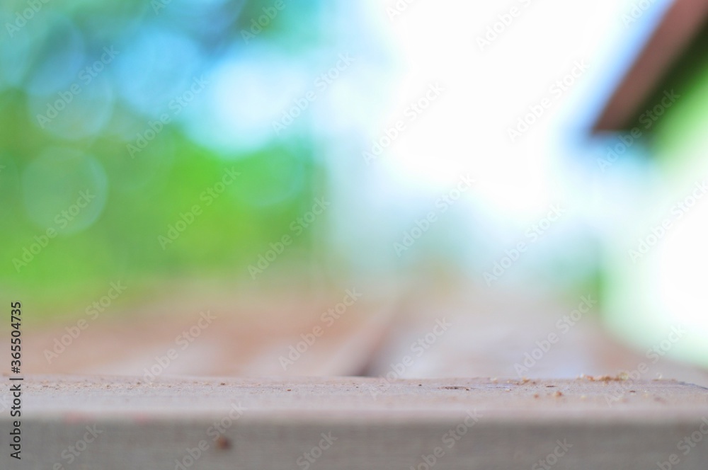 Wooden board on green bokeh background. Can be used for display or montage your products. Wooden board on green bokeh background. Can be used for display or montage your products.