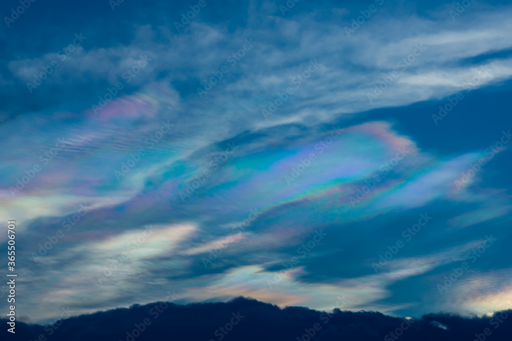 The beauty of the rainbow clouds Above the black clouds in the evening. The beauty of the rainbow clouds Above the black clouds in the evening.