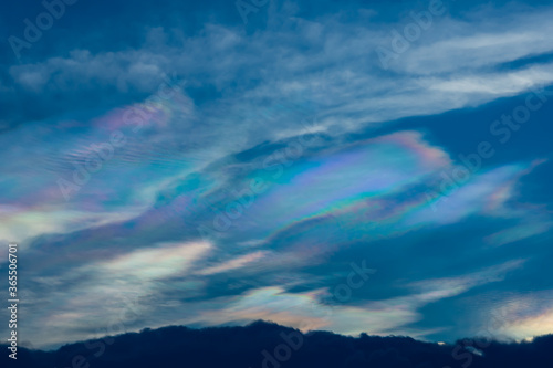 The beauty of the rainbow clouds Above the black clouds in the evening.