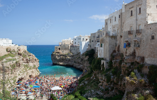 People relax and swimming on lovely beach Lama Monachile in Polignano a Mare photo