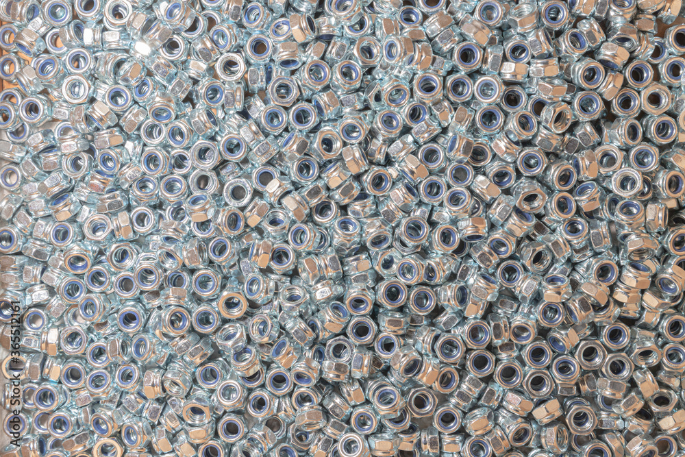 Nuts. Texture. A lot of rubberized nuts for bolts and screws. Background for wallpaper. Female screw. Screw-nut. Internal screw. Nuts. Texture. A lot of rubberized nuts for bolts and screws. Background for wallpaper. Female screw. Screw-nut. Internal screw.
