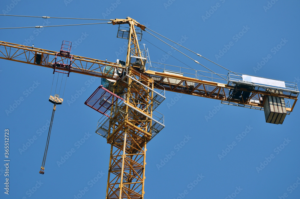 Construction crane close-up against a blue sky Construction crane close-up against a blue sky