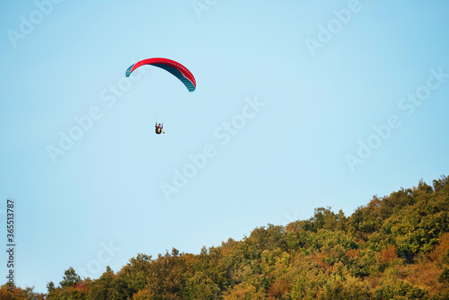 Paraglider flying over the hills