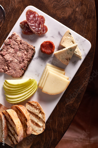 Charcuterie Meat and Cheese Plate on Marble and Wood