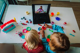 Kids play with clay molding shapes during online lesson