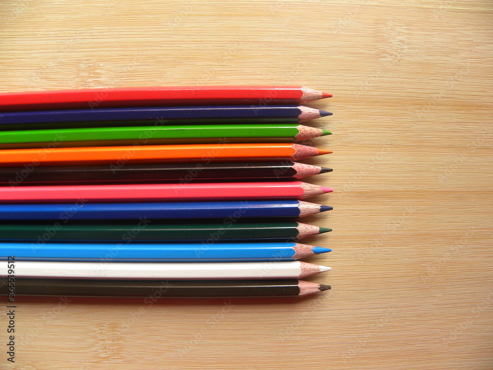 Fototapeta premium Many color pencils kept on wooden table