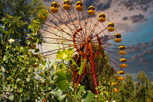 Iconic pripyat ferris wheel in the exclusion zone on a golden red sunset in the summer. Red almost burning sky indicating recent forest and wildfires photo