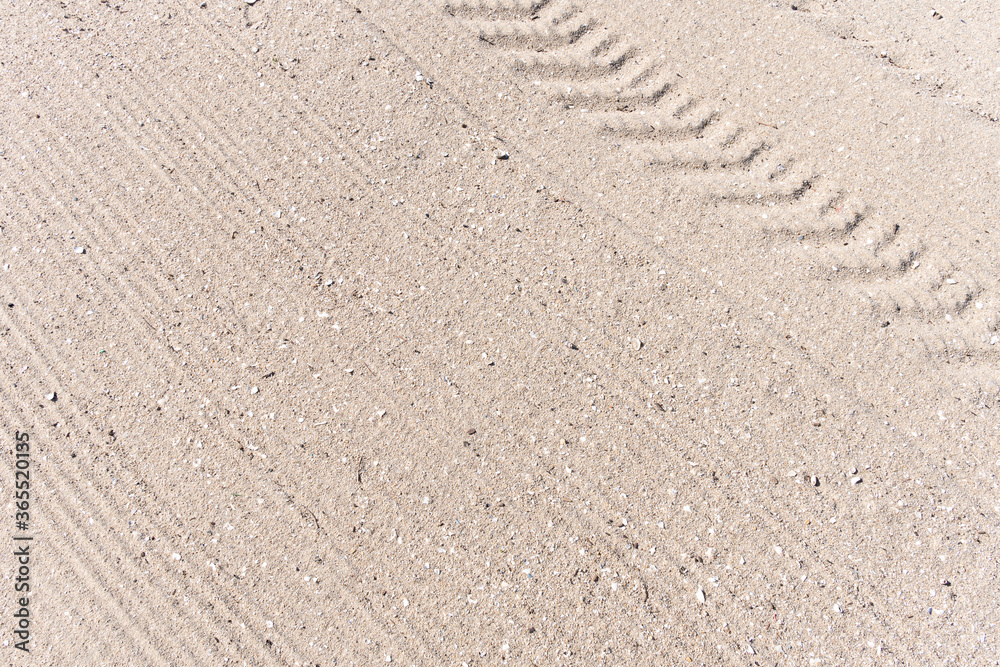 Sand beach background with Truck trail on cleaning surface Sand beach background with Truck trail on cleaning surface
