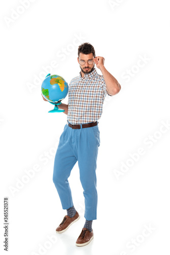 Handsome nerd in eyeglasses holding globe on white background © LIGHTFIELD STUDIOS