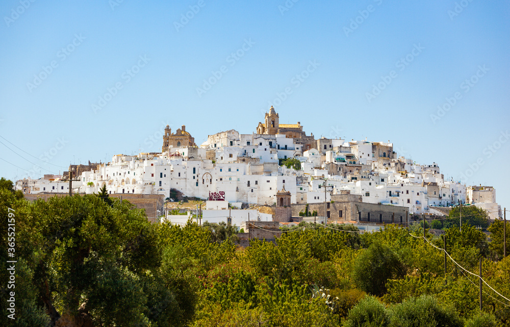 Panoramic view of the white and old city of Ostuni on a hilltop and with the cathedral on top