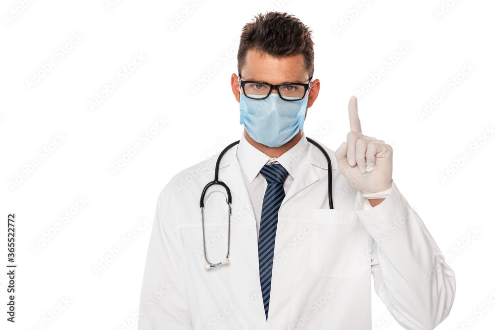 Doctor in medical mask with stethoscope pointing with finger isolated on white