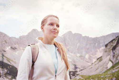 Young Caucasian woman traveling in the mountains of Durmitor National Park in Montenegro. Real grain scanned film.