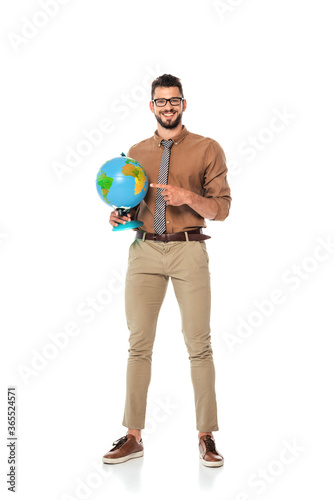 Smiling teacher pointing with finger at globe on white background © LIGHTFIELD STUDIOS