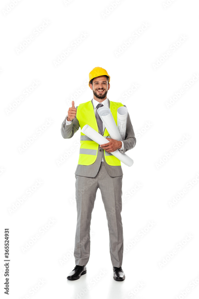 Smiling engineer showing like gesture and holding blueprints on white background Smiling engineer showing like gesture and holding blueprints on white background