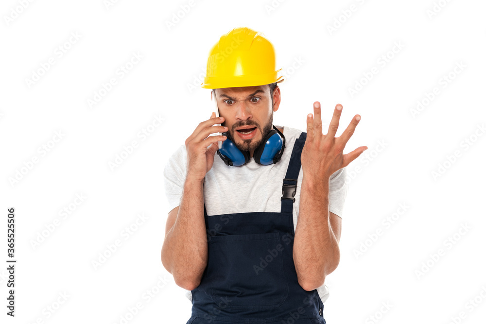 Angry workman gesturing while talking on smartphone isolated on white Angry workman gesturing while talking on smartphone isolated on white