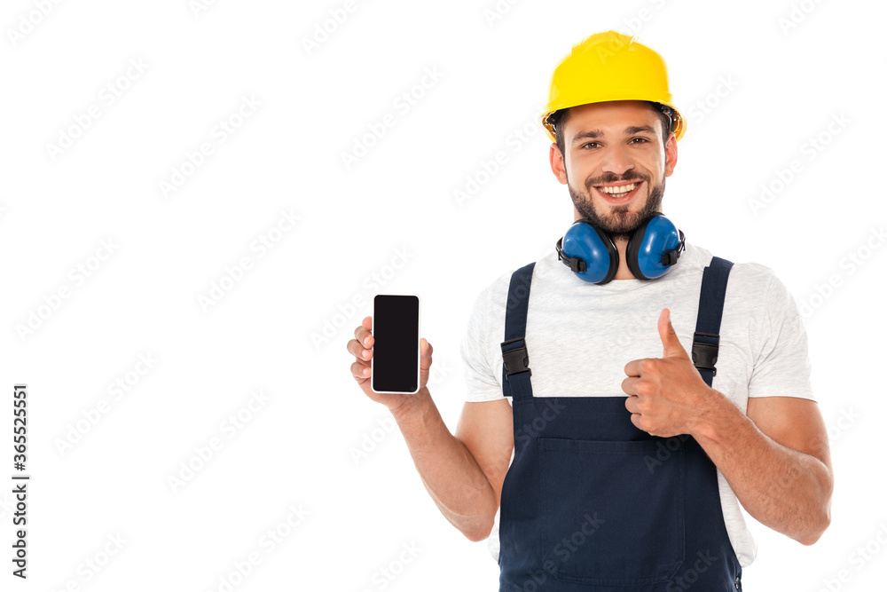 Smiling handyman in workwear showing like gesture while holding smartphone with blank screen isolated on white Smiling handyman in workwear showing like gesture while holding smartphone with blank screen isolated on white