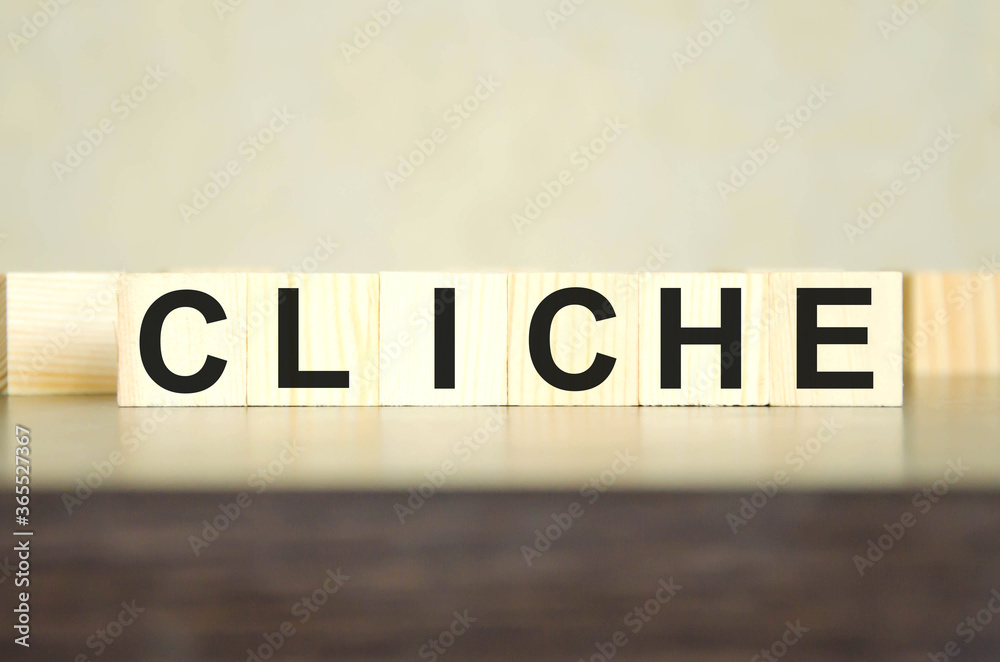 Obraz premium text cliche written on cubes and dark background. environmental impact. the influence of money