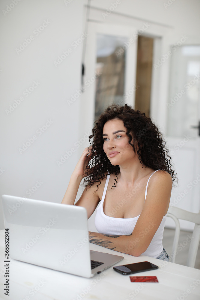 Young woman working at home with laptop shopping and surfing internet