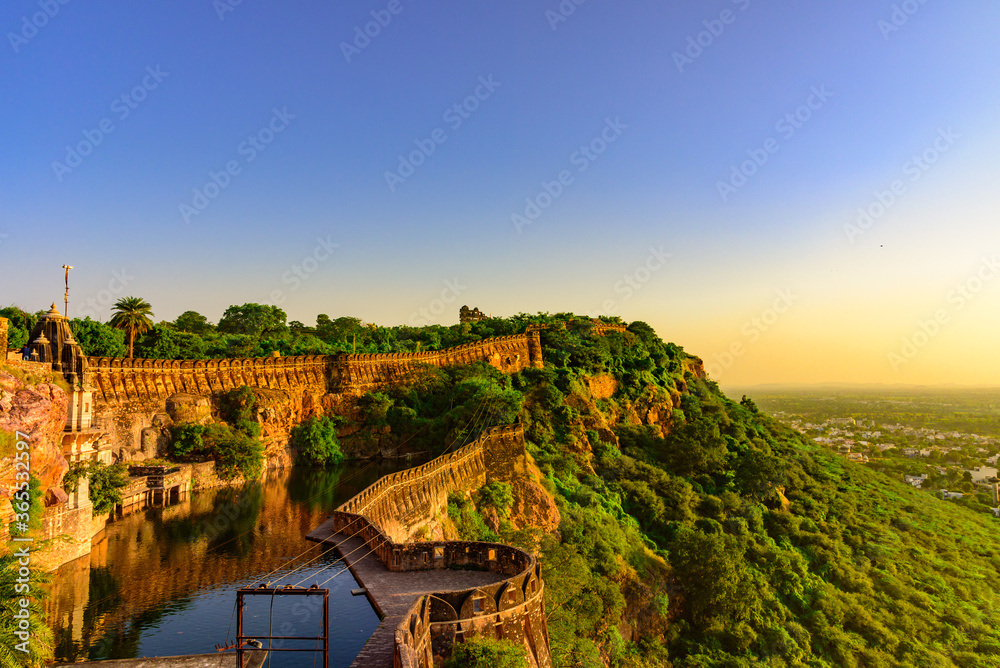 View during sunset from Chittor or Chittorgarh Fort with city in backdrop. It is one of the largest forts in India & listed in the UNESCO World Heritage Sites list as Hill Forts of Rajasthan. View during sunset from Chittor or Chittorgarh Fort with city in backdrop. It is one of the largest forts in India & listed in the UNESCO World Heritage Sites list as Hill Forts of Rajasthan.