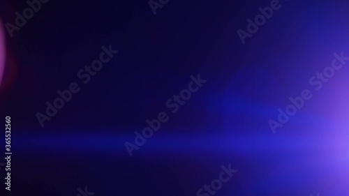 Short blue anamorphic lens flare strobing and moving on the right side of frame