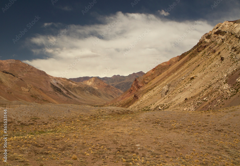 Geology. Panorama view of the golden meadow, valley and rocky mountains.
