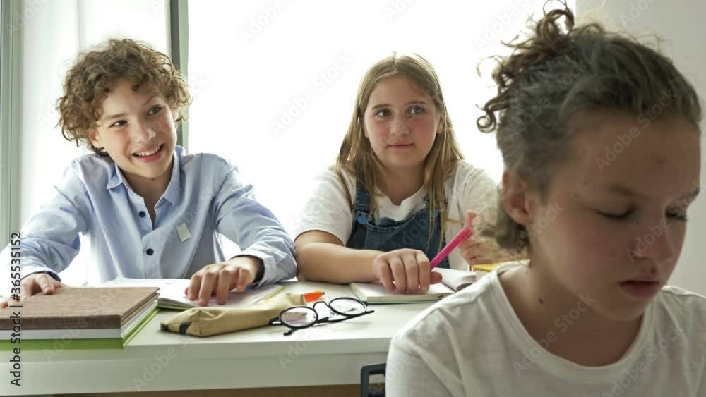 Two teens scoff at their defenseless classmate. Child cruelty. School bullying. Two teens scoff at their defenseless classmate. Child cruelty. School bullying.