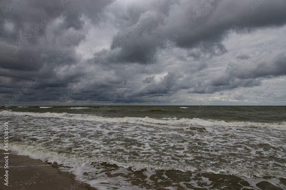 wide beach on the Baltic Sea in Poland on a summer cloudy gray cold day