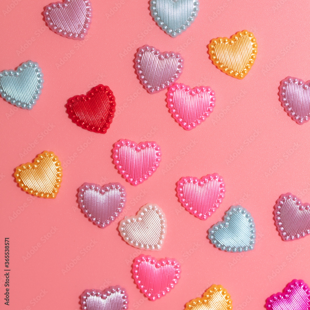 Multi-colored hearts on a pink background. Multi-colored hearts on a pink background.