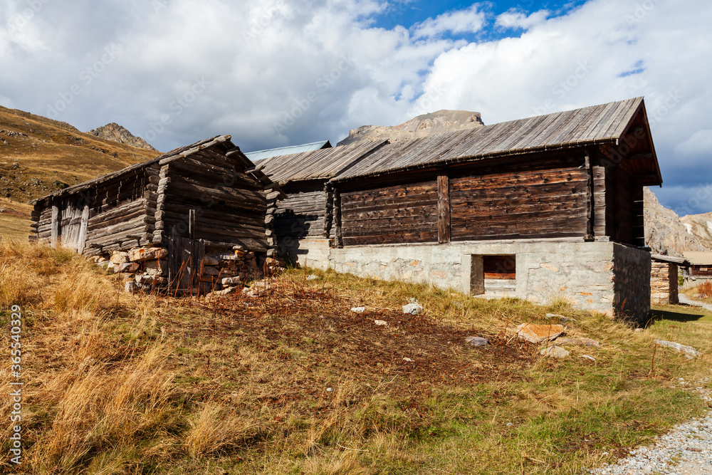 Wooden and stone made huts in Alps Mountains. Alpine rural rustic architecture, Arvieux, France, Europe. Wooden and stone made huts in Alps Mountains. Alpine rural rustic architecture, Arvieux, France, Europe.