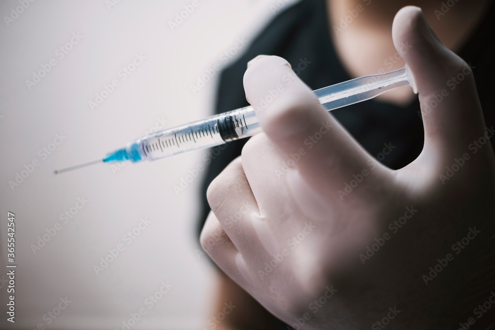 Male nurse protected with vaccine ready to inject Male nurse protected with vaccine ready to inject