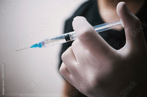 Male nurse protected with vaccine ready to inject