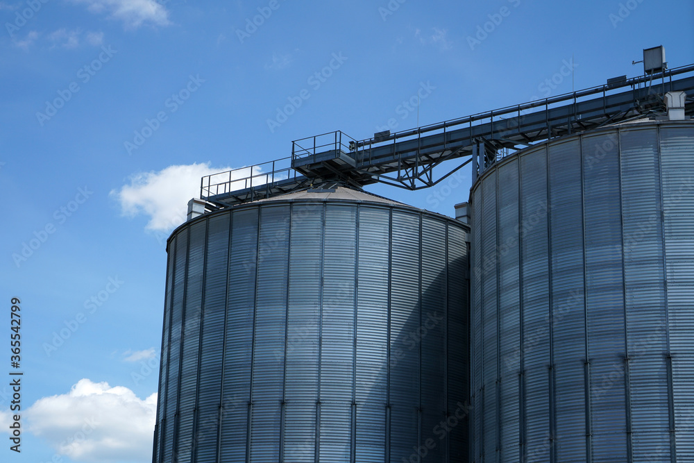 An old rusted silo photographed in a port area in summer An old rusted silo photographed in a port area in summer