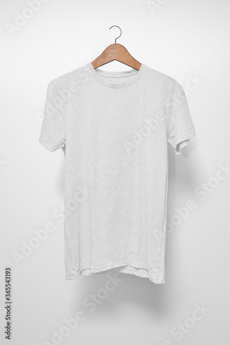 White T-Shirt on a hanger against a white background