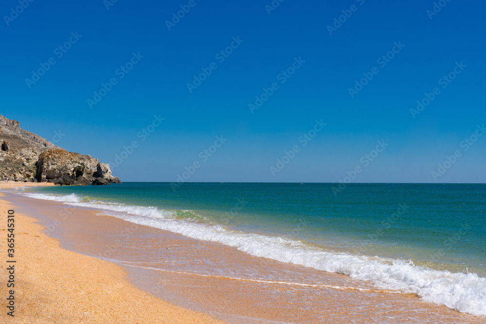 the azure turquoise sea with yellow sand from shells