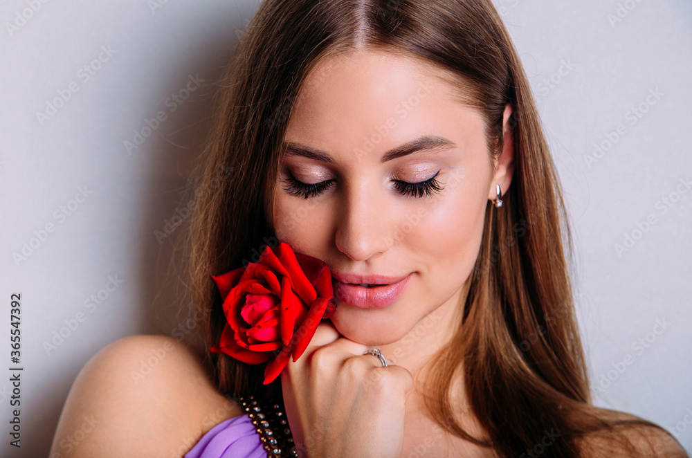 close-up portrait of beautiful model woman with red rose in her hand. close-up portrait of beautiful model woman with red rose in her hand.