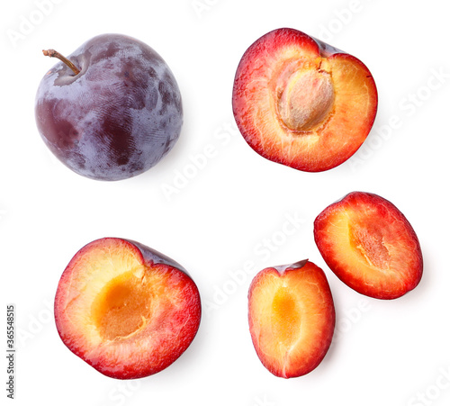 Photo Set of plums whole, half and piece on a white background, isolated