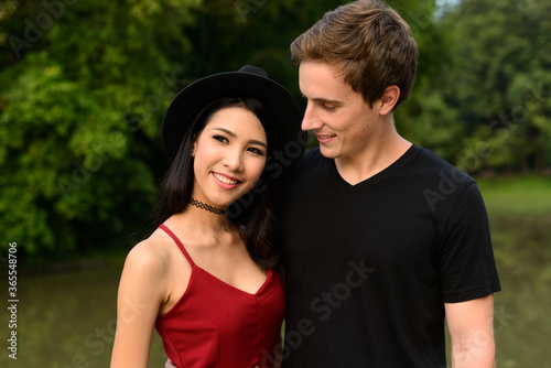 Portrait of multi ethnic couple together and in love at the park