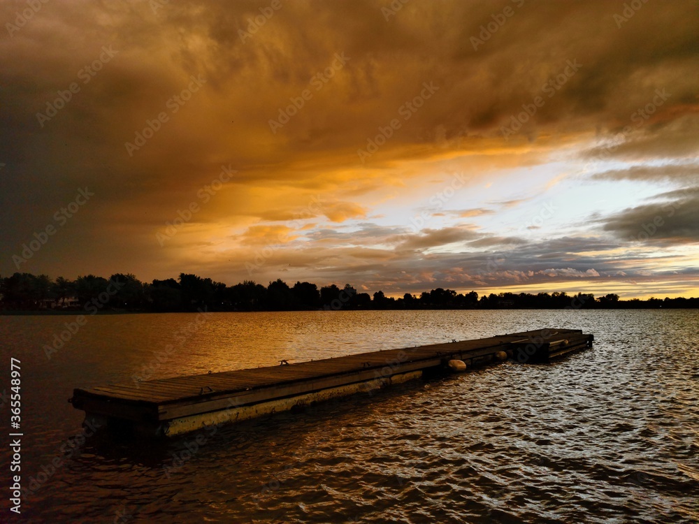 Obraz premium dock sunset over the river