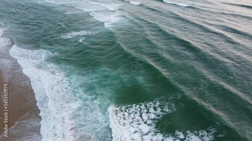 Aerial shot of waves breaking on the beach photo