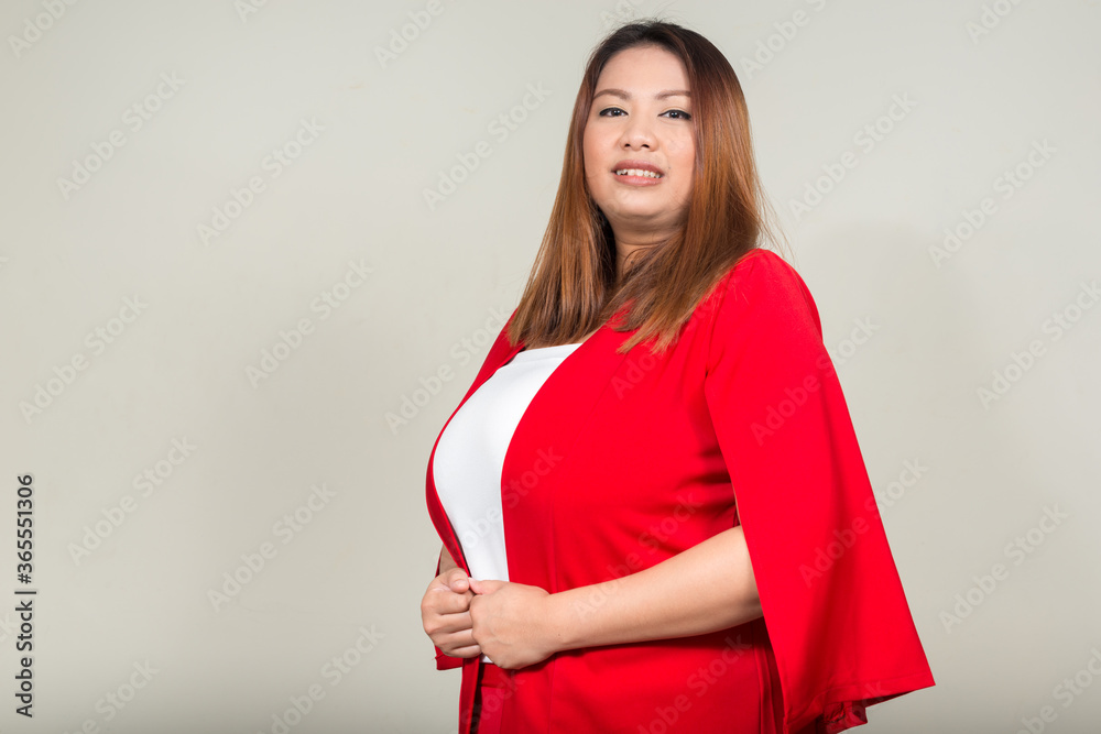 Portrait of young beautiful overweight Asian businesswoman Portrait of young beautiful overweight Asian businesswoman