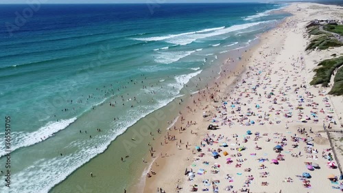 Aerial shot of Biscarrosse Plage in the middle of the summer afternoon with lots of people on the beach and in the water photo