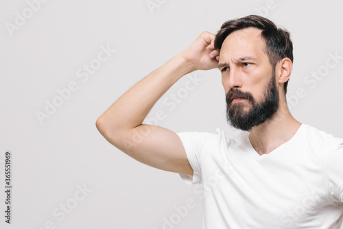 Studio portrait of man with short haircut standin. white background. High quality photo © Yuliya