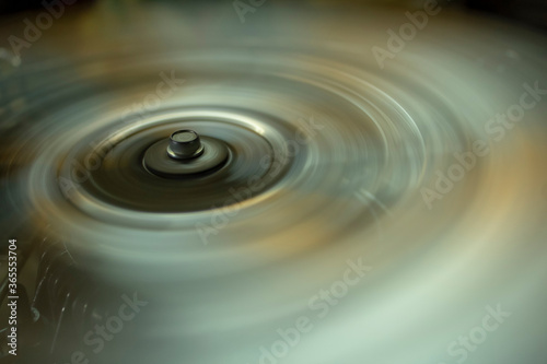 Fotografija circle with a bolt head on the metal blades of a rotating fan.