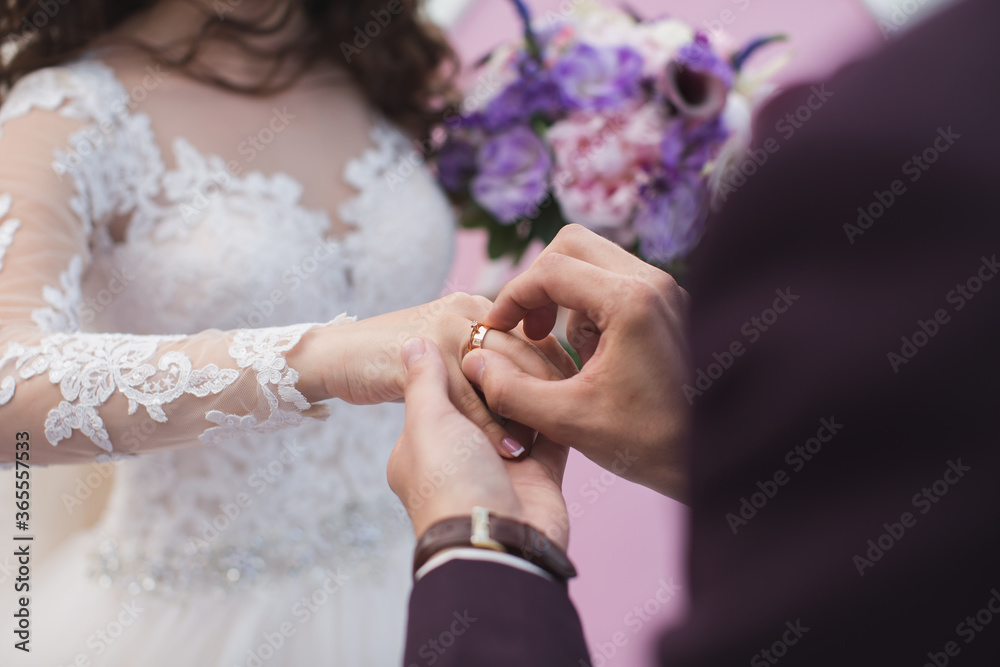 Fototapeta premium Groom wears the ring bride.