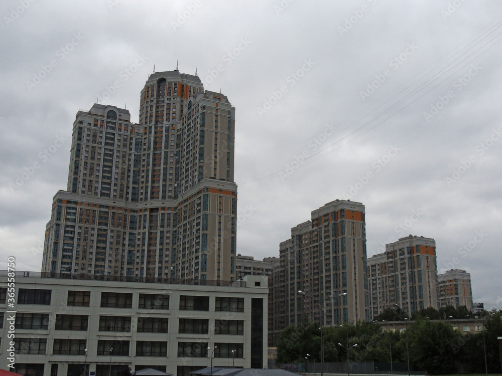 elements of multi-storey residential buildings in the background sky.