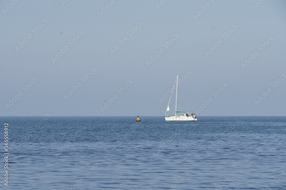 View of a white yacht over the calm blue sea