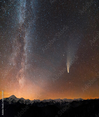 Night landscape of mountains with stars covered Milky Way sky and Neowise comet with light tail. photo