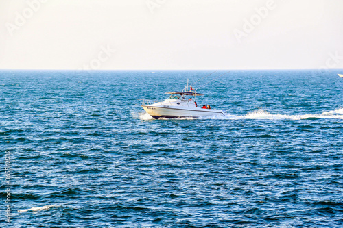 Luxury yacht speeding on Arabian sea in Dubai, United Arab Emirates