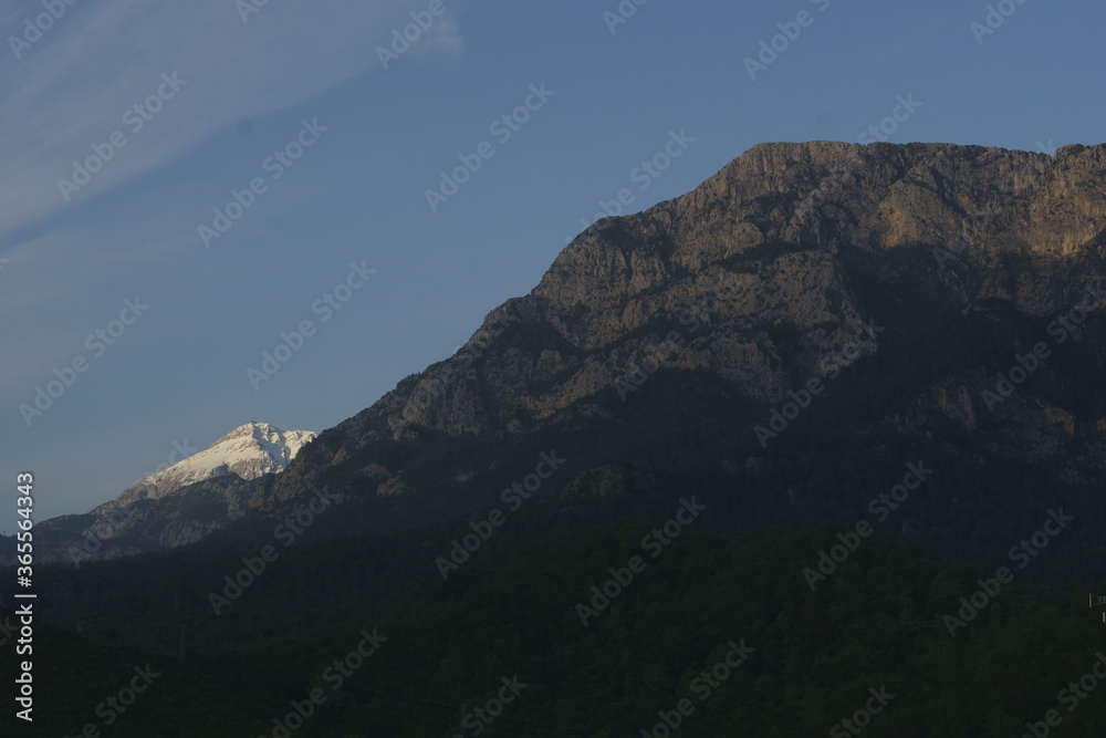 View of the mountain peaks covered with snow in sunrise