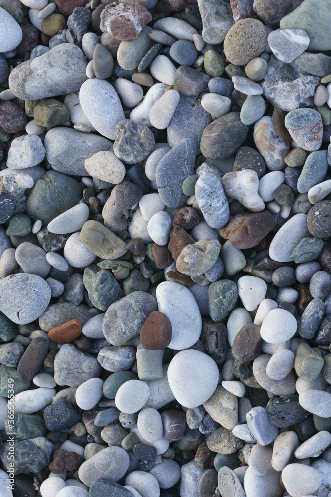 Closeup view of small stones on the beach with colorful pattern Closeup view of small stones on the beach with colorful pattern